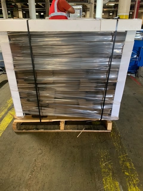 Palletized wall panel shipment with stretch wrap, corner protectors, and banding